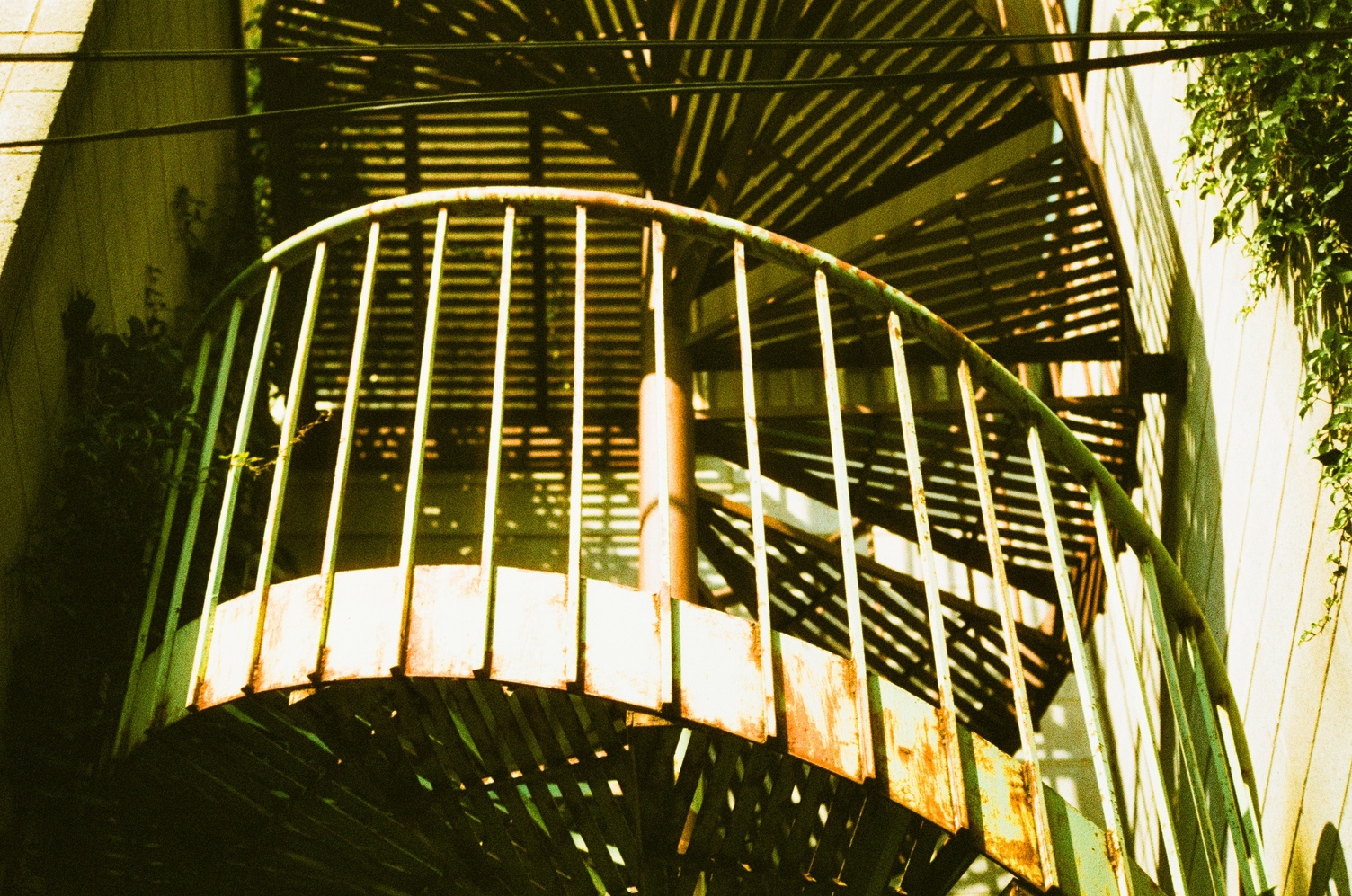 a painted spiral staircase
enclosed on three sides
by exterior walls.