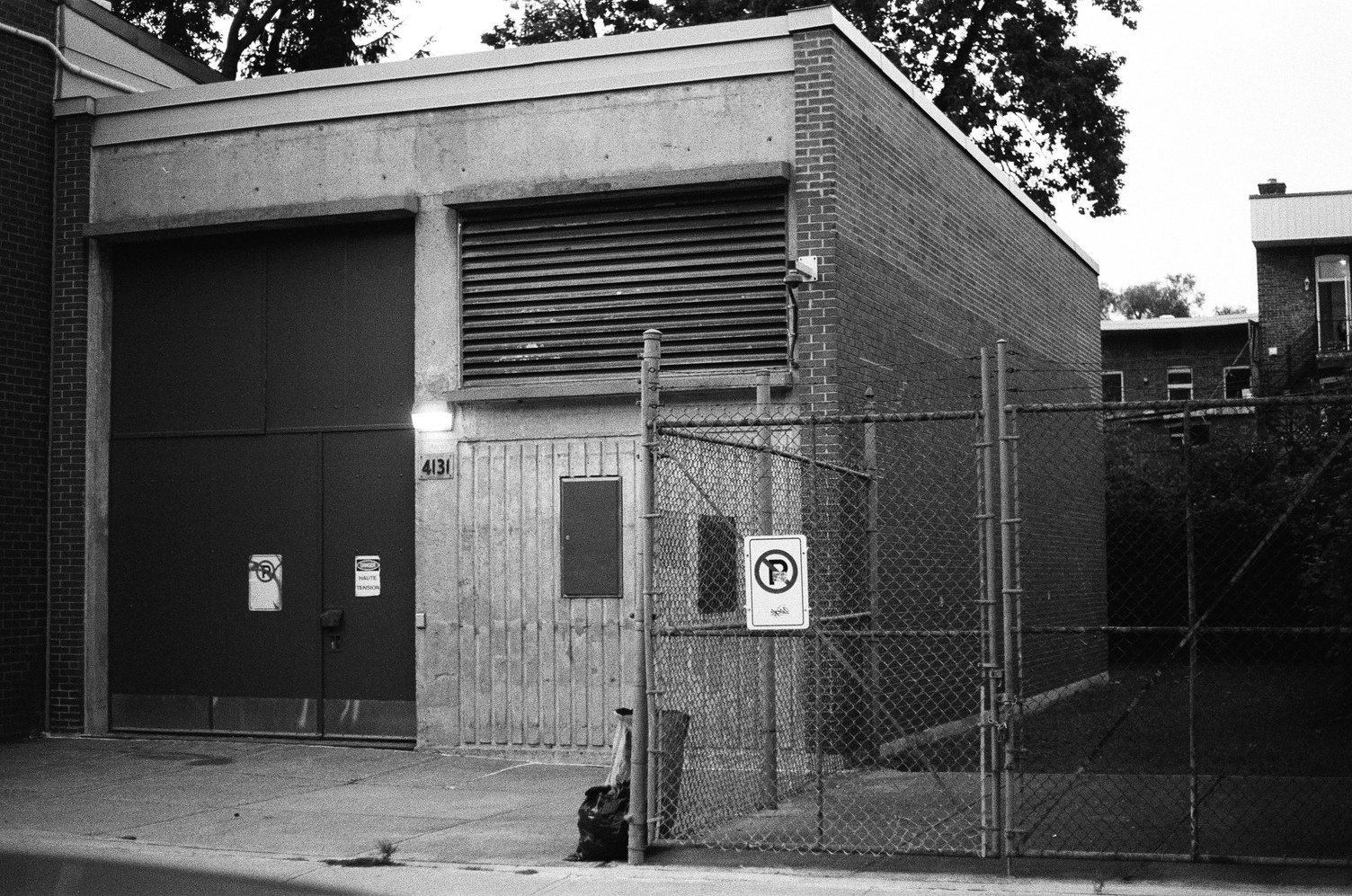 some sort of small power station type building.
its address is 4131,
and there's a lamp above that number.
to the right there's a fenced off area.