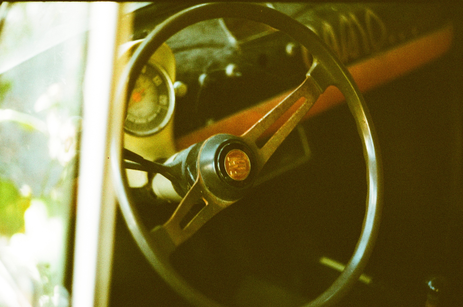 the steering wheel of an old presumably european car
that has been left to rot in an alley.