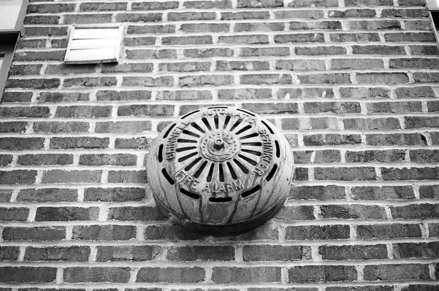 an automatic sprinkler fire alarm
on an external brick wall.