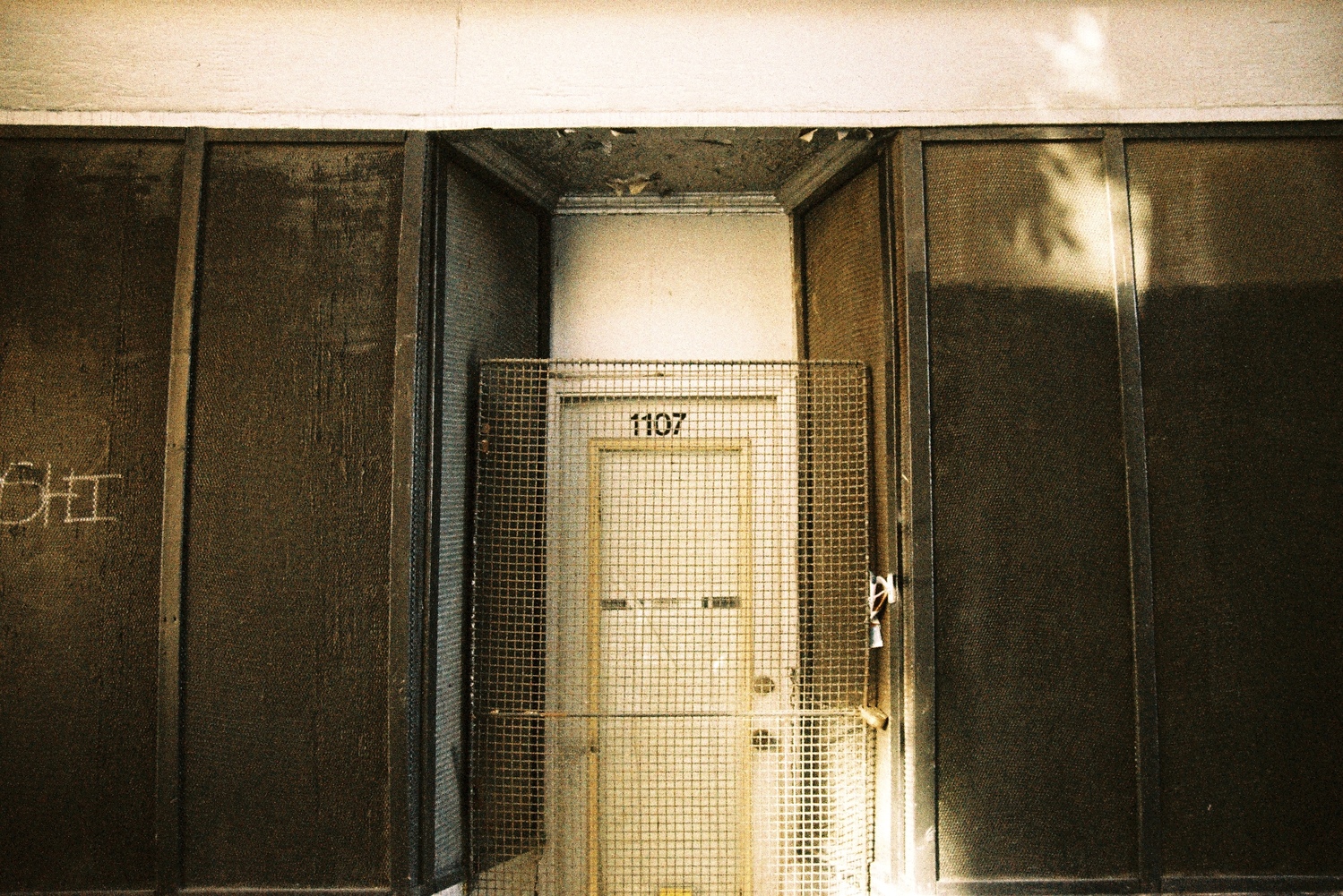 what may have been a storefront
with the address 1107.
it's a door set into the building
behind a locked metal grate.