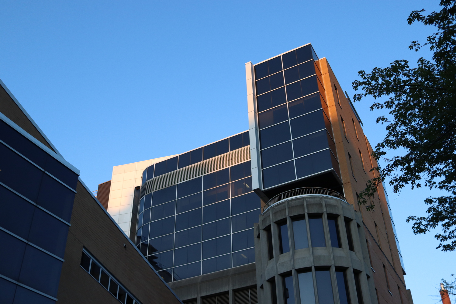 a building of many intersecting shapes
at sunset.
brick, glass and concrete.
only the top of the building is in direct sunlight.